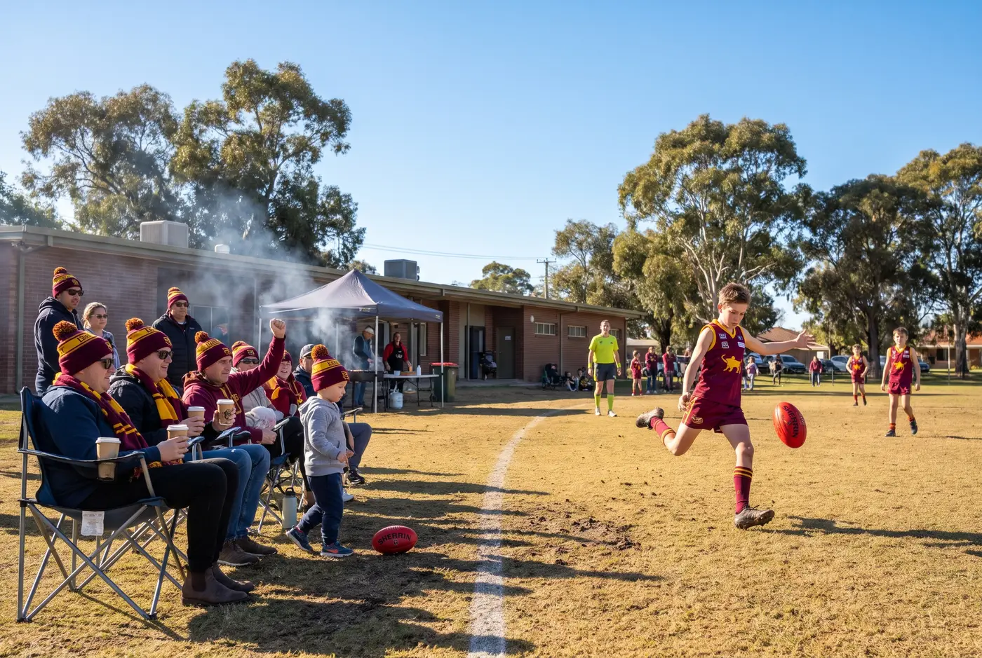 Families watching junior footy from the boundary